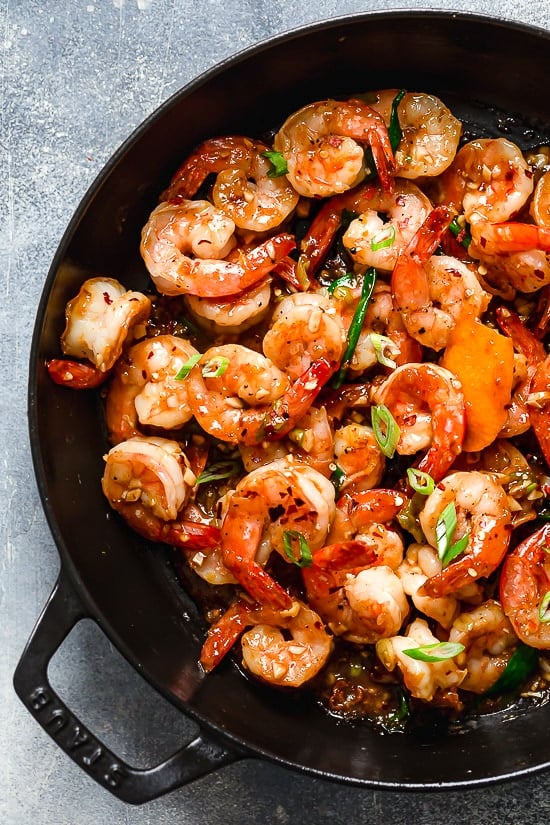 For a quick and easy weeknight dinner, you will love this easy Asian Honey Garlic Shrimp recipe! It’s sweet, spicy, savory, and so good. Skillet of honey garlic shrimp