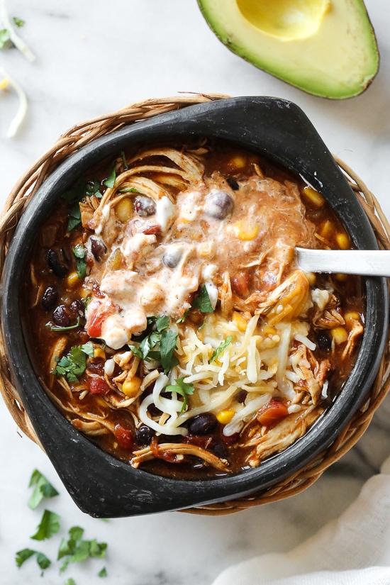 This easy and healthy Instant Pot Chicken Taco Chili is made with chicken, beans, corn and tomatoes and taco seasoning. A bowl of Instant Pot chicken chili topped with cheese