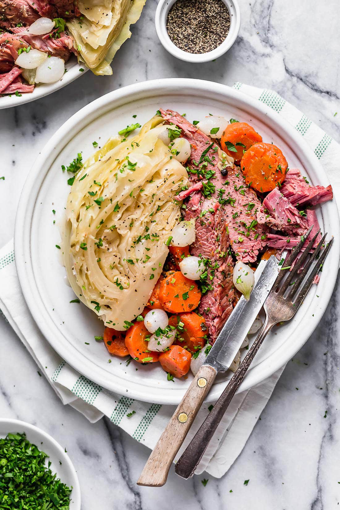 This easy Instant Pot Corned Beef and Cabbage recipe comes out perfectly tender every time! The perfect St. Patrick's Day dinner. Overhead view of a plate of corned beef and cabbage with carrots