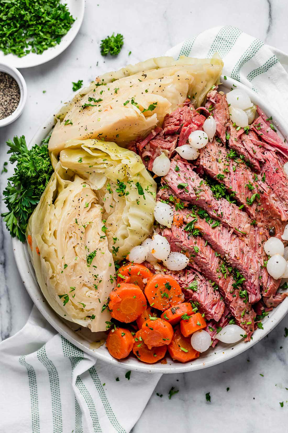 This easy Instant Pot Corned Beef and Cabbage recipe comes out perfectly tender every time! The perfect St. Patrick's Day dinner. A plate of sliced corned beef and cabbage