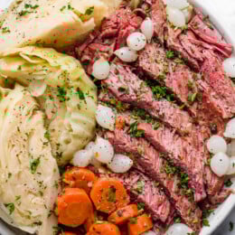A plate of corned beef, cabbage, carrots, and onions