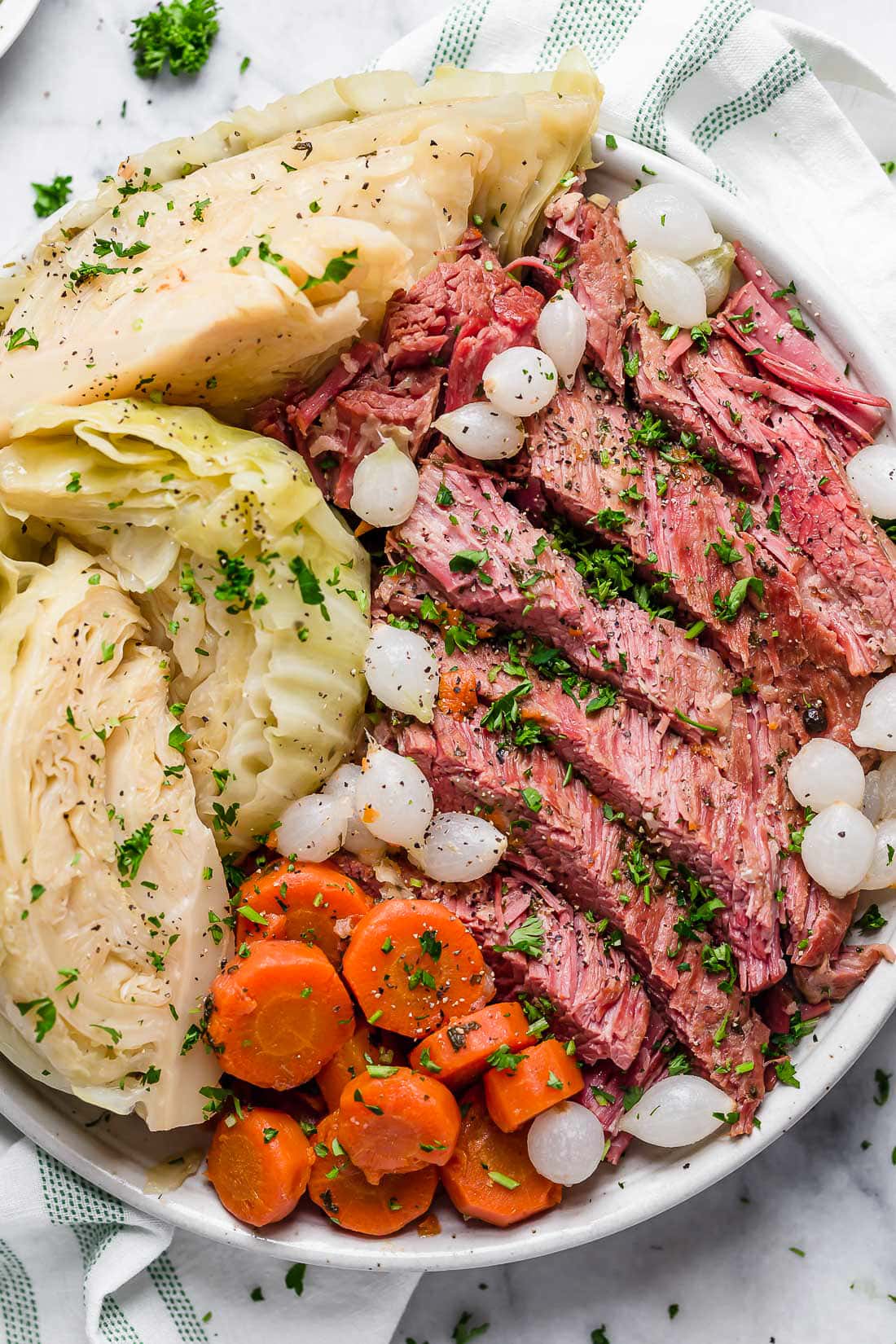 This easy Instant Pot Corned Beef and Cabbage recipe comes out perfectly tender every time! The perfect St. Patrick's Day dinner. A plate of corned beef, cabbage, carrots, and onions