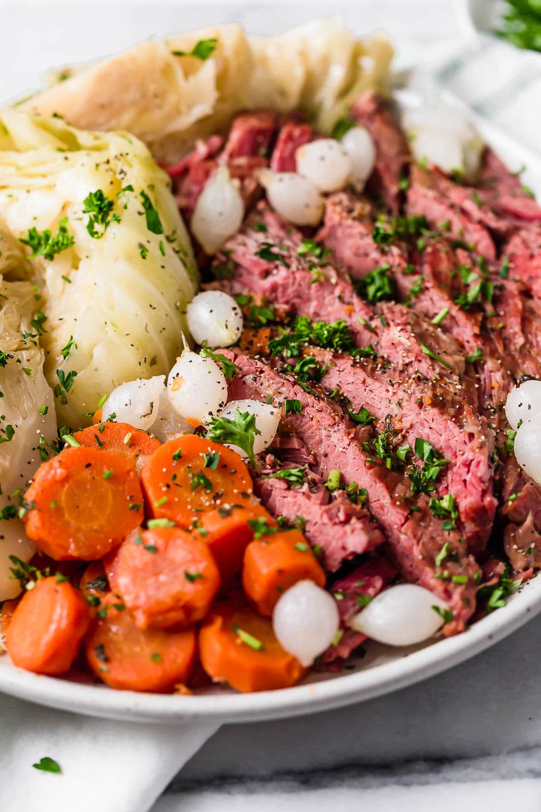 This easy Instant Pot Corned Beef and Cabbage recipe comes out perfectly tender every time! The perfect St. Patrick's Day dinner. A plate of corned beef and cabbage