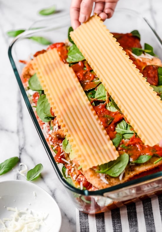 This easy Chicken Parmesan Lasagna is a combination of two classic dishes. It's the perfect family-friendly dish to feed a large crowd! Lasagna noodles layered on top of chicken cutlets