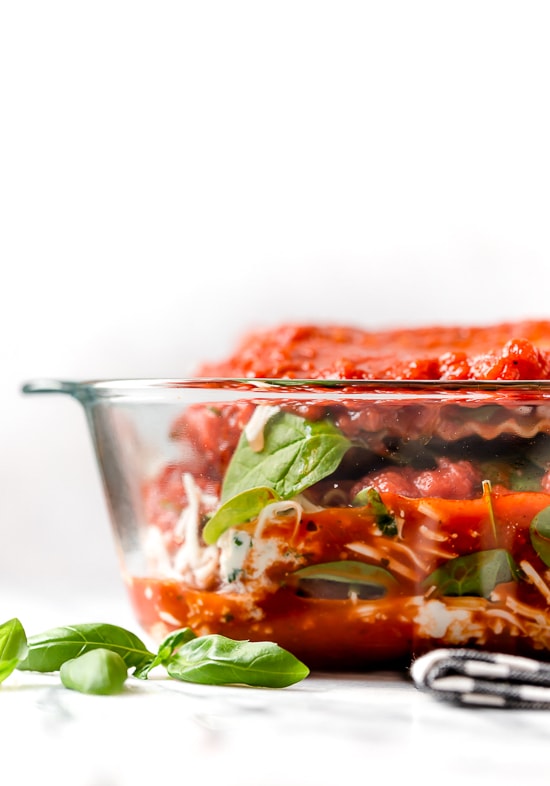 This easy Chicken Parmesan Lasagna is a combination of two classic dishes. It's the perfect family-friendly dish to feed a large crowd! The outside of a casserole dish with chicken parm lasagna