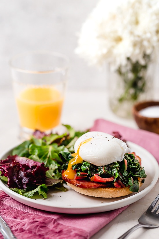 I love this lighter take on Eggs Benedict made with Canadian bacon, Swiss chard and poached eggs on a whole wheat English muffin. Perfect for breakfast or brunch!