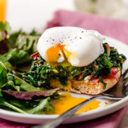 I love this lighter take on Eggs Benedict made with Canadian bacon, Swiss chard and poached eggs on a whole wheat English muffin. Perfect for breakfast or brunch!