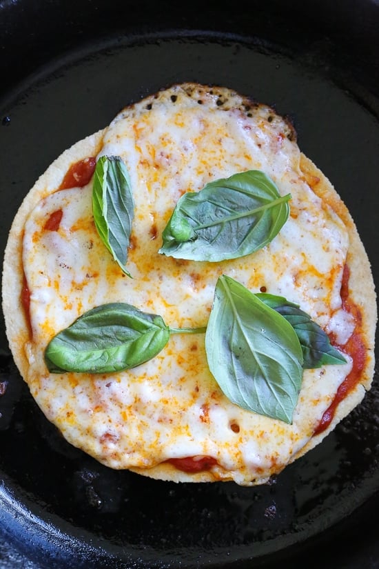 I'm obsessed with this Super-Quick Cast-Iron Pizza technique made with tortillas.This combined stove top and oven recipe comes out just like Domino's or any bar thin crust pizza!