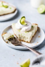 This easy Key Lime Yogurt Pie is a cross between a key lime pie and a key lime cheesecake with a light, creamy filling that is sweet and tart, made with key lime juice, yogurt and cream cheese in a graham cracker crust.