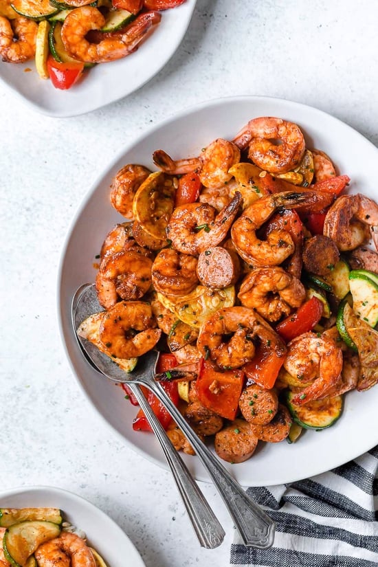 This fast and easy Air Fryer Cajun Shrimp recipe is a meal-in-one, made with shrimp, sausage, and lots of colorful vegetables such as zucchini, yellow squash and bell peppers.