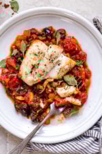 This healthy Mediterranean Sea Bass is smothered in a piquant, healthy, Mediterranean-inspired sauce made from tomatoes, white wine, fennel and olives.