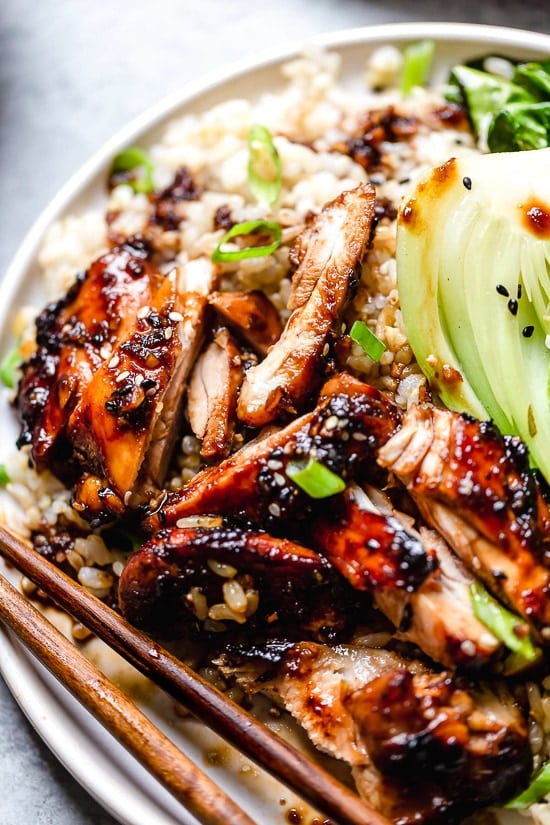 Asian Glazed Chicken Thighs sliced up on a plate.