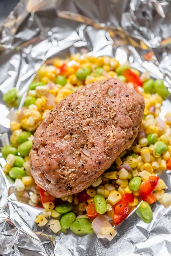 These Campfire Meatloaf Foil Packets are great for camping, glamping or for an easy weeknight dinner. Each packet has individual turkey meatloaves slathered with BBQ sauce cooked over summer succotash.