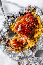 These Campfire Meatloaf Foil Packets are great for camping, glamping or for an easy weeknight dinner. Each packet has individual turkey meatloaves slathered with BBQ sauce cooked over summer succotash.