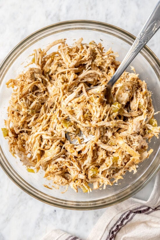 Crispy air fryer chicken chimichangas are an easy and healthier twist on the classic! Filled with cheese, green chiles, and seasoned chicken. Seasoned shredded chicken filling for chimichangas