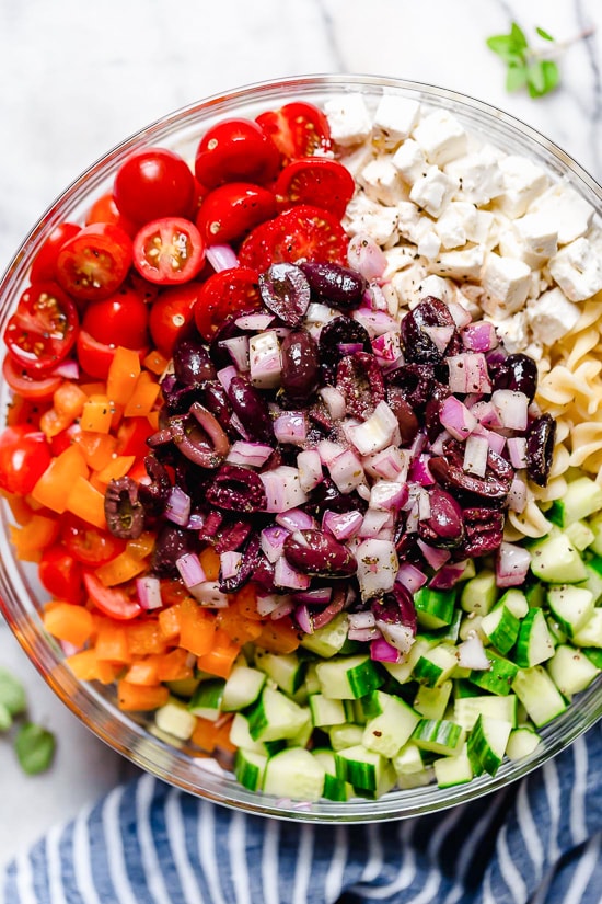 This Greek Pasta Salad is light and fresh, loaded with garden tomatoes, bell peppers and cucumbers tossed in a homemade Greek dressing with Kalamata olives and Feta cheese. Perfect for summer parties or potlucks!