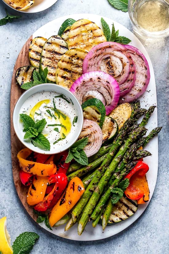 This beautiful, Grilled Vegetable Platter with Yogurt Mint Sauce is so colorful. An easy summer side dish made with asparagus, zucchini, squash, red onion and bell peppers.