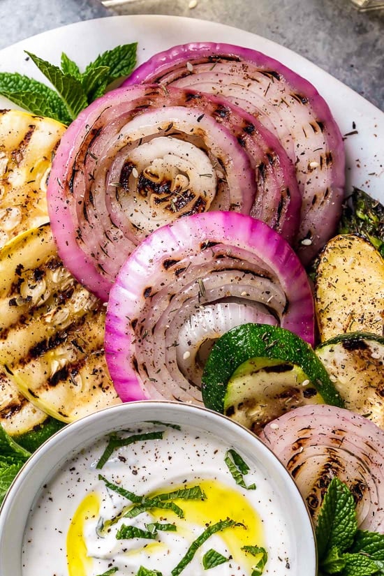This beautiful, Grilled Vegetable Platter with Yogurt Mint Sauce is so colorful. An easy summer side dish made with asparagus, zucchini, squash, red onion and bell peppers.