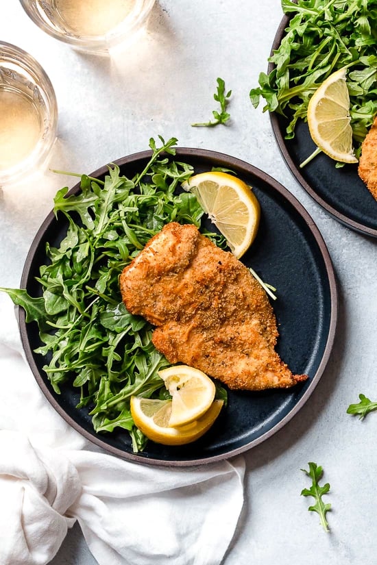 Air Fryer Chicken Milanese with Arugula and lemon wedges is one of my favorite dinners!