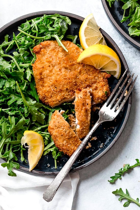Air Fryer Chicken Milanese with Arugula and lemon wedges is one of my favorite dinners!