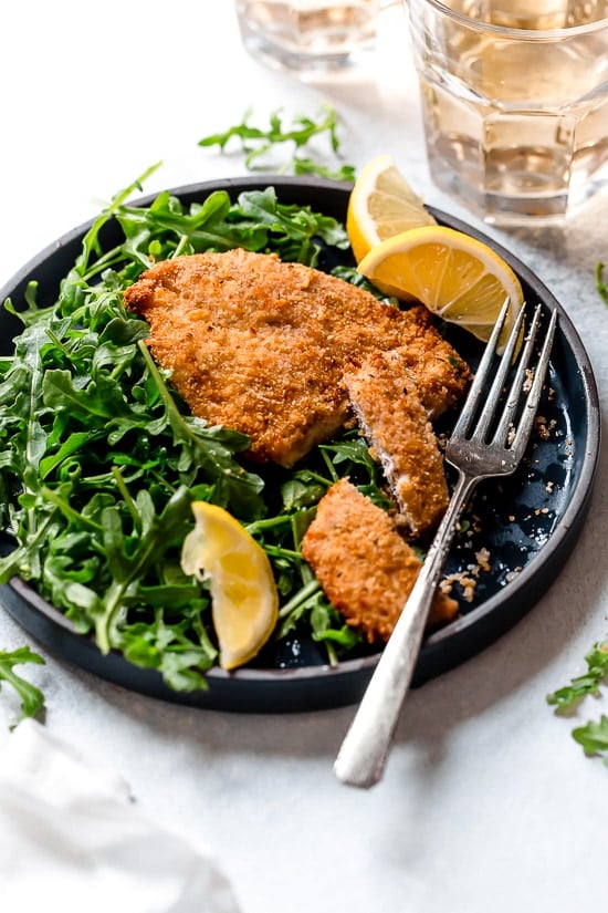Air Fryer Chicken Milanese with Arugula and lemon wedges is one of my favorite dinners!