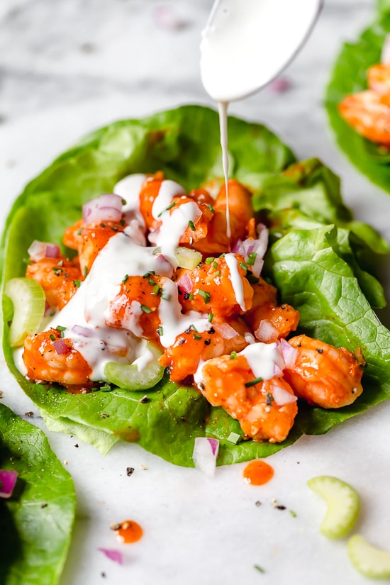 These easy, low-carb Buffalo Shrimp Lettuce Wraps are spicy, light and delicious topped with celery and blue cheese or ranch dressing.
