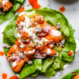 These easy, low-barb Buffalo Shrimp Lettuce Wraps are spicy, light and delicious topped with celery and blue cheese or ranch dressing.