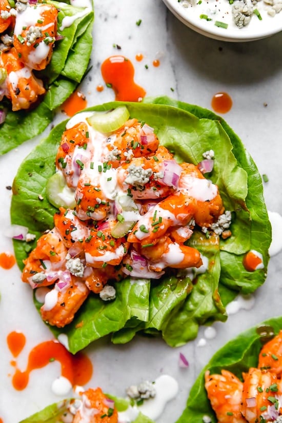 These easy, low-carb Buffalo Shrimp Lettuce Wraps are spicy, light and delicious topped with celery and blue cheese or ranch dressing.