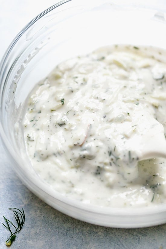 Tzatziki Fish Tacos have a Greek twist! Made with breaded white fish filet topped with mint tzatziki sauce.