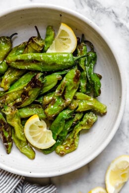 Air Fried Shishito Peppers come out charred and blistered with the air fryer, which uses much less oil! A squeeze of lemon over the top and they are delicious!
