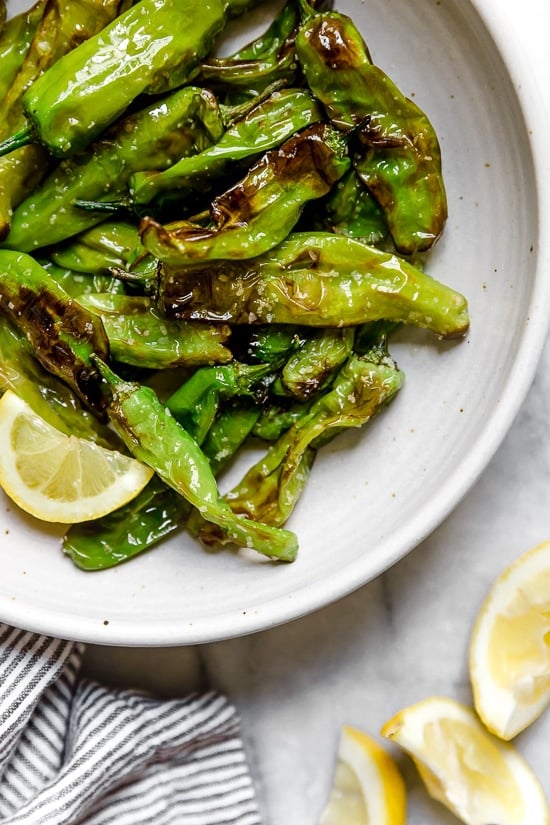 Air Fried Shishito Peppers come out charred and blistered with the air fryer, which uses much less oil! A squeeze of lemon over the top and they are delicious!