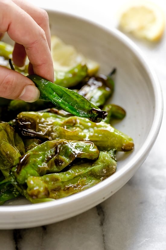 Air Fried Shishito Peppers come out charred and blistered with the air fryer, which uses much less oil! A squeeze of lemon over the top and they are delicious!