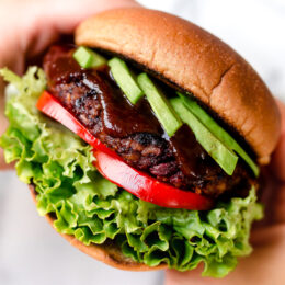 This is a veggie burger that even hearty meat-eaters will love! Made with beans, oats, brown rice, beets and a whole lot of spices, this veggie burger is a real crowd pleaser.