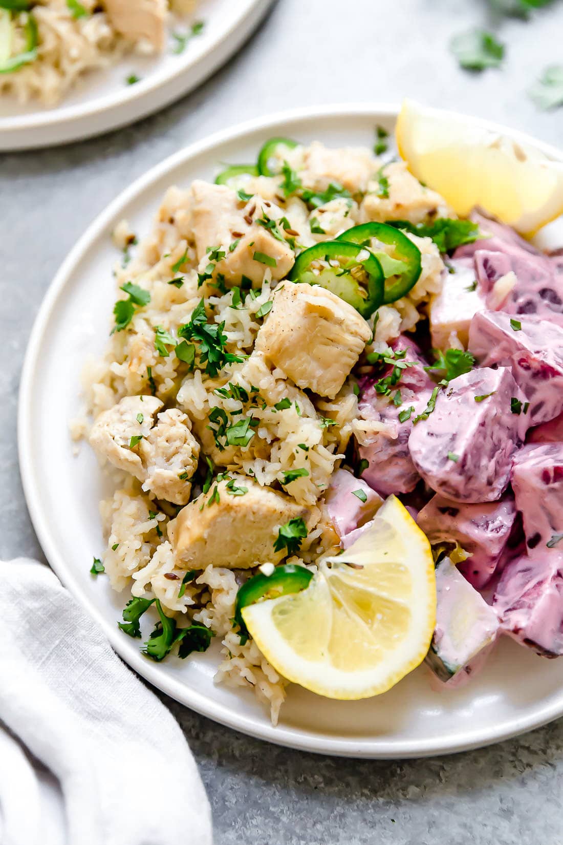 Instant Pot Chicken Pulao comes together in just 30 minutes, with basmati rice, chicken breasts, and a few aromatics and spices. A plate of chicken pulao with lemon wedges