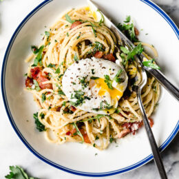 Spaghetti Carbonara is an Italian pasta dish with creamy egg, diced bacon, grated cheese, and copious amounts of black pepper–a Roman dish reminiscent of an American breakfast.