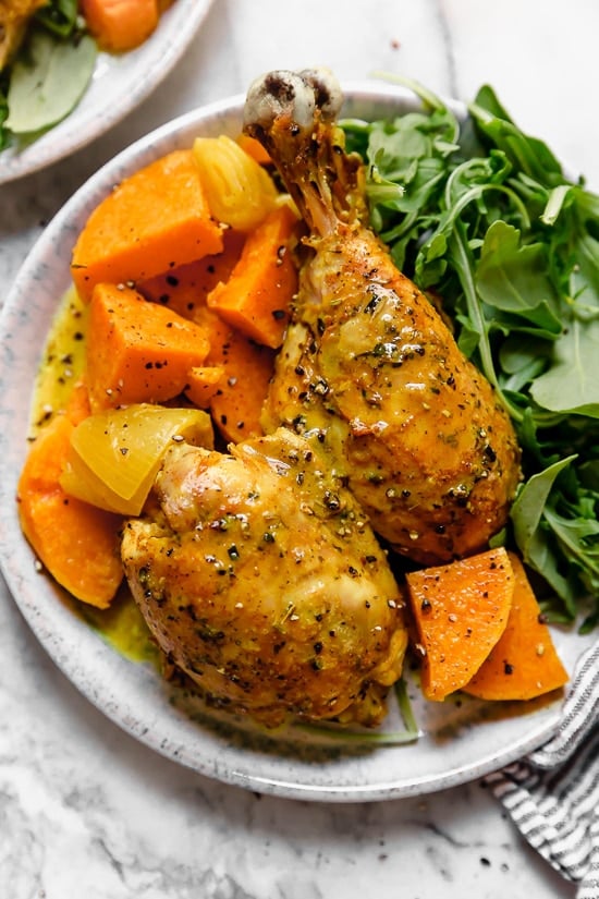 Caramelized sweet potatoes and shallots are the bed for roasted chicken thighs and legs that come together in this one-pot healthy chicken dinner.