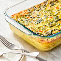This easy Breakfast Casserole recipe is made with eggs, spinach, tomatoes and Feta cheese and only takes a few minutes to whip up. You can make it ahead of time, so it’s the perfect breakfast egg casserole for Christmas morning or any day!
