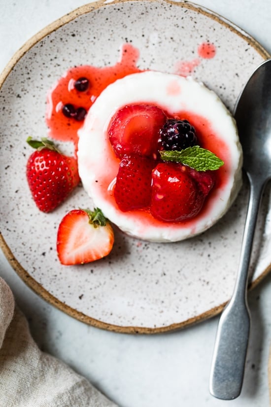 This simple Yogurt Panna Cotta is the perfect smooth, creamy dessert. The cool tang of yogurt pairs perfectly with fresh berries. To macerate the berries simple mix them with a little sugar and let them sit.