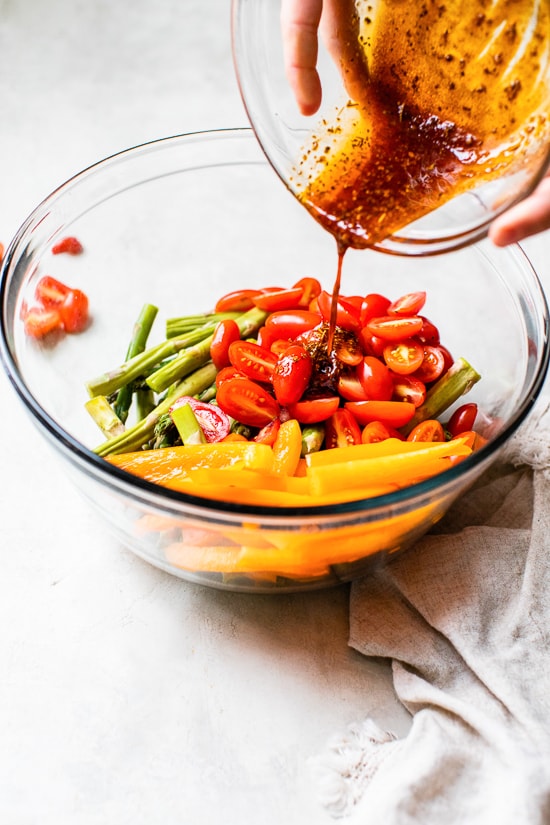 Mixing veggies in a bowl.