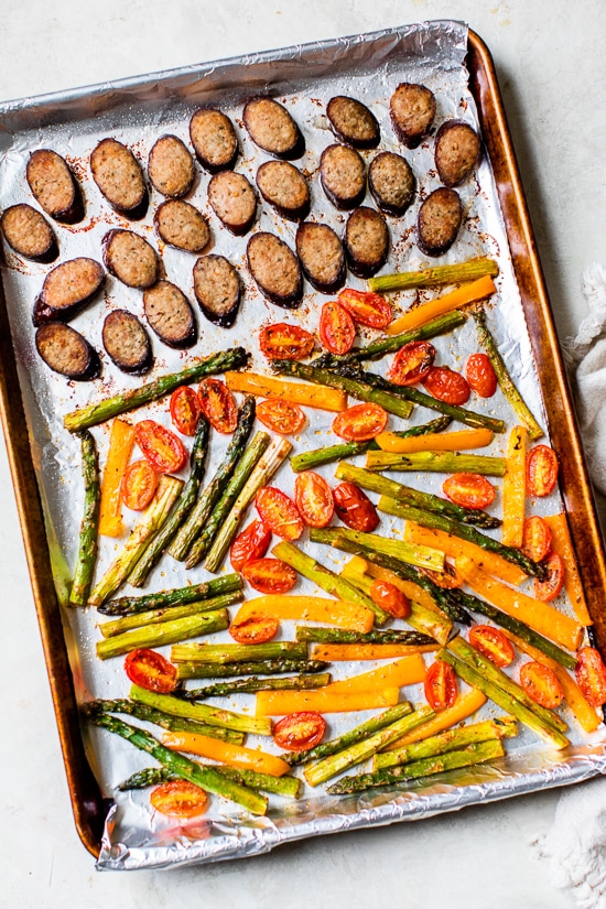 Kielbasa Veggie Sheet Pan Dinner is made with turkey kielbasa, asparagus, tomatoes and bell peppers cooked all on one pan, easy cleanup! It's also Keto, Whole30, Low Carb and Gluten-free.