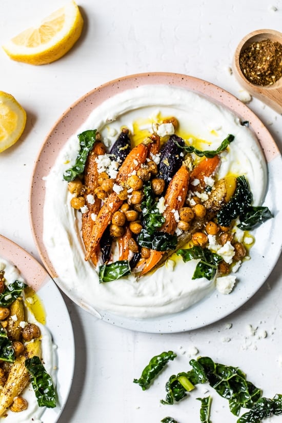 Roasted Carrots and Chickpeas seasoned with za’atar and served over Greek yogurt with lemony kale makes a wonderful side dish or meatless main!