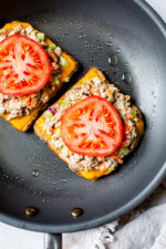 open faced tuna melt with cheddar and tomato in a skillet
