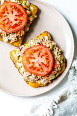 Tuna salad on bread with cheese and tomato