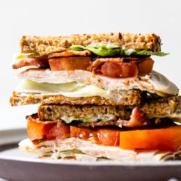 A classic Turkey Club sandwich made healthy, piled high with turkey breast, bacon, lettuce, and tomato on whole grain bread, the perfect easy lunch.