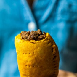 Girl holding a Jamaican Beef Patty