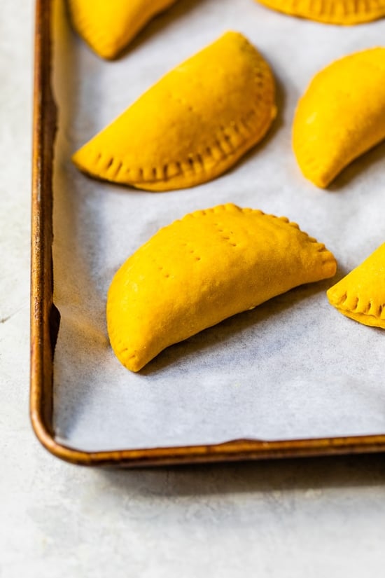 beef patties on a baking sheet