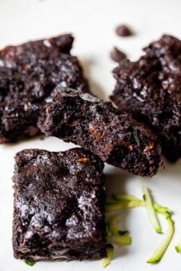 Flourless Zucchini Brownies piled on parchment paper