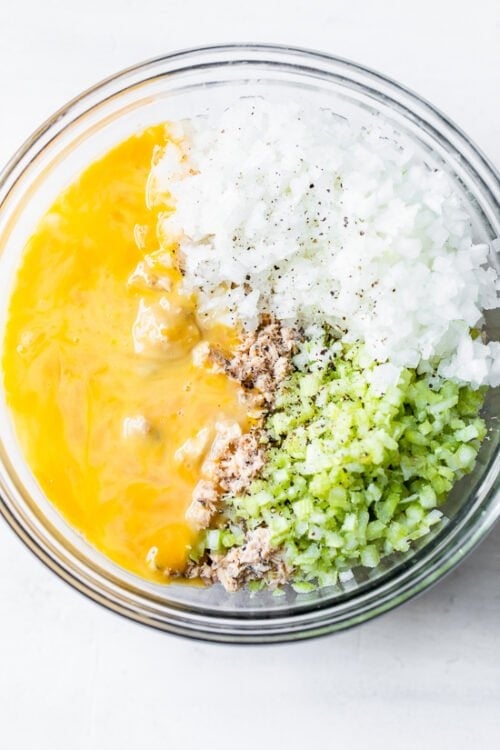 salmon, onion, celery and egg in a bowl