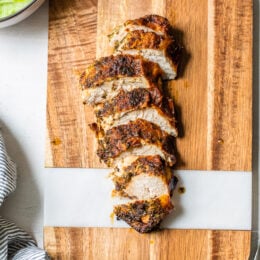 sliced chicken breast on cutting board