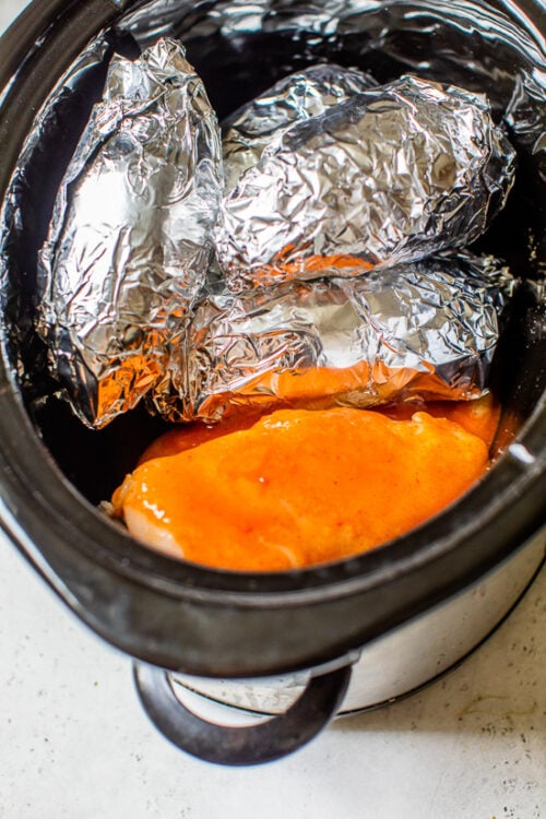 Slow cooker with sweet potatoes and chicken.